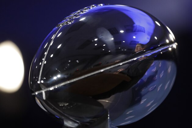 New England Patriots head coach Bill Belichick is reflected in the Lombardi Trophy during a news conference after the NFL Super Bowl 51 football game Monday, Feb. 6, 2017, in Houston. (AP Photo/David J. Phillip)