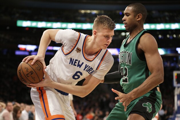 New York Knicks' Kristaps Porzingis, left, moves against Boston Celtics' Al Horford during the first half of the NBA basketball game, Sunday, April 2, 2017, in New York. (AP Photo/Seth Wenig)