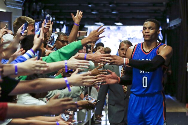 Oklahoma City Thunder's Russell Westbrook (0) is greeted by fans as he leaves the court after an NBA basketball game against the Orlando Magic, Wednesday, March 29, 2017, in Orlando, Fla. Oklahoma won 114-106 in overtime. (AP Photo/John Raoux)