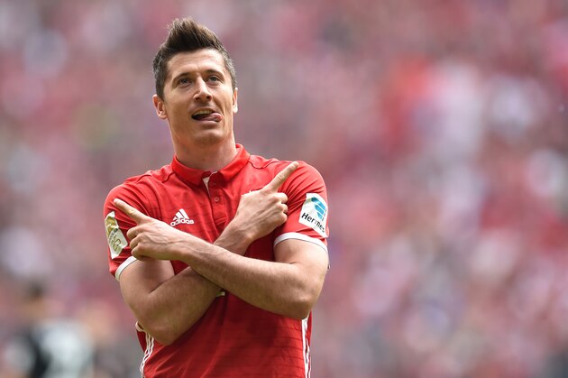 Bayern Munich's Polish striker Robert Lewandowski celebrates after scoring the 1-0 during the German first division Bundesliga football match between FC Schalke 04 and Borussia Dortmund in Gelsenkirchen, western Germany, on April 1, 2017. / AFP PHOTO / Christof STACHE / RESTRICTIONS: DURING MATCH TIME: DFL RULES TO LIMIT THE ONLINE USAGE TO 15 PICTURES PER MATCH AND FORBID IMAGE SEQUENCES TO SIMULATE VIDEO. == RESTRICTED TO EDITORIAL USE == FOR FURTHER QUERIES PLEASE CONTACT DFL DIRECTLY AT + 49 69 650050
        (Photo credit should read CHRISTOF STACHE/AFP/Getty Images)