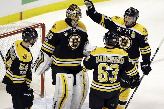 Boston Bruins goalie Tuukka Rask (40) is congratulated by center Patrice Bergeron (37), left wing Brad Marchand (63), and defenseman Adam McQuaid (54) after the team's NHL hockey game against the Dallas Stars, Thursday, March 30, 2017, in Boston. The Bruins won 2-0. (AP Photo/Elise Amendola)
