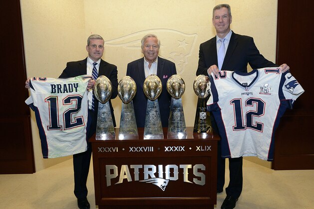 In this photo released by the Federal Bureau of Investigation, Harold H. Shaw, left, Special Agent in Charge of the FBI Boston Division and Colonel Richard D. McKeon, right, of the Massachusetts State Police, hold two recovered Super Bowl jerseys worn by New England Patriots quarterback Tom Brady, beside team owner Robert Kraft, center, on Thursday, March 23, 2017 in the NFL football team's trophy room at Gillette Stadium in Foxborough, Mass. Brady's jersey went missing from the Patriots' locker room after their Super Bowl win over the Atlanta Falcons on Feb. 5, setting off an investigation that stretched from Boston to the Mexican border. (FBI via AP)