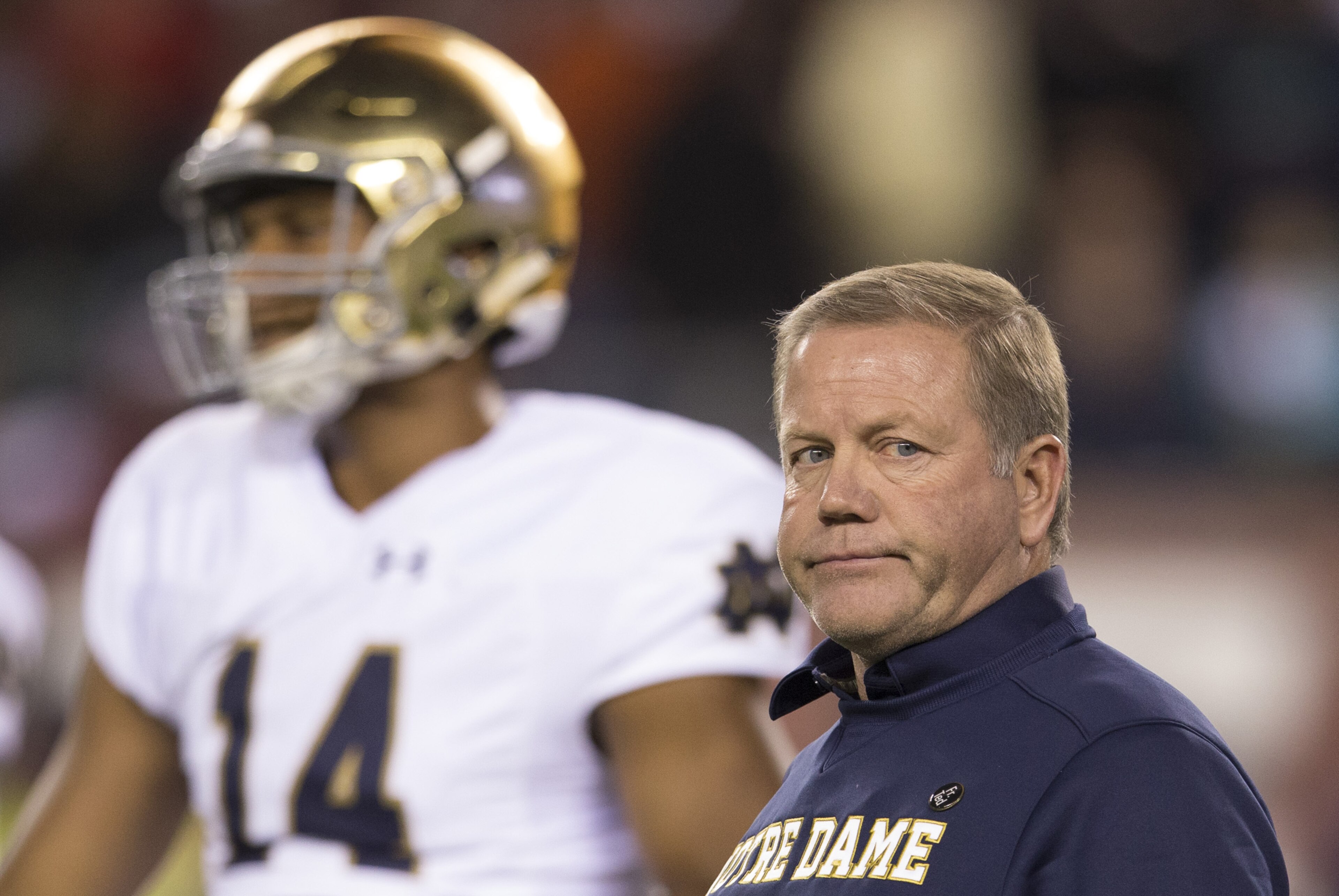 PHILADELPHIA, PA - OCTOBER 31: Head coach Brian Kelly of the Notre Dame Fighting Irish looks on while DeShone Kizer #14 warms up prior to the game against the Temple Owls on October 31, 2015 at Lincoln Financial Field in Philadelphia, Pennsylvania. (Photo by Mitchell Leff/Getty Images)