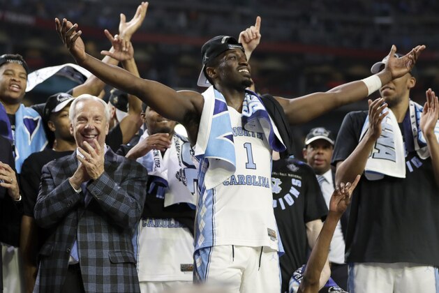 North Carolina's Theo Pinson (1) celerates with head coach Roy Williams and the rest of the players after the finals of the Final Four NCAA college basketball tournament against Gonzaga, Monday, April 3, 2017, in Glendale, Ariz. North Carolina won 71-65. (AP Photo/Mark Humphrey)