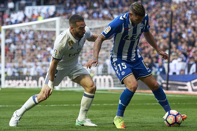MADRID, SPAIN - APRIL 02:  Daniel Carvajal (L) of Real Madrid competes for the ball with Theo Hernandez of Deportivo Alaves during the La Liga match between Real Madrid and Deportivo Alaves at Estadio Santiago Bernabeu on April 2, 2017 in Madrid, Spain.  (Photo by fotopress/Getty Images)