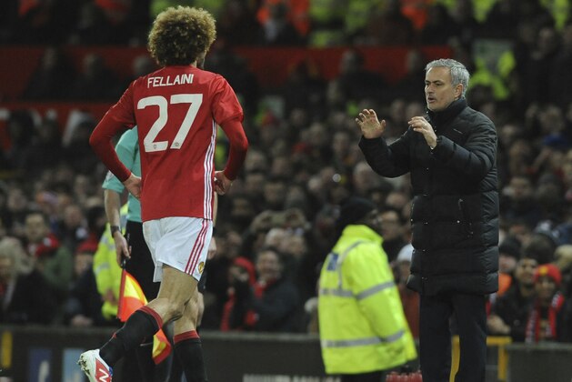 Manchester United's Marouane Fellaini runs towards Manchester United's manager Jose Mourinho, to celebrates after he scored his sides second goal of the game during the English League Cup semifinal, 1st leg, soccer match between Manchester United and Hull at Old Trafford stadium in Manchester, England, Tuesday, Jan. 10, 2017. (AP Photo/Rui Vieira)