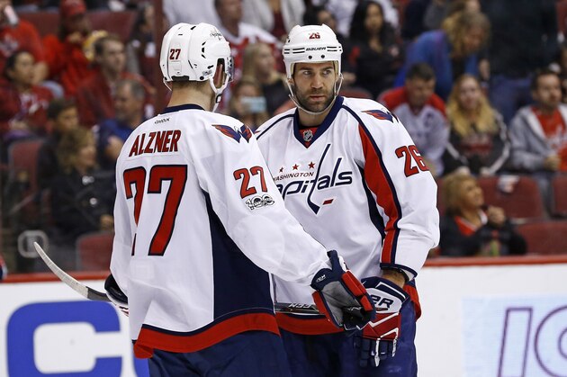 Washington Capitals' Daniel Winnik (26) talks with Karl Alzner (27) during the second period of an NHL hockey game against the Arizona Coyotes Friday, March 31, 2017, in Glendale, Ariz. The Coyotes defeated the Capitals 6-3. (AP Photo/Ross D. Franklin)