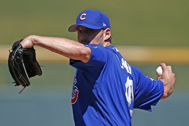 Chicago Cubs' John Lackey warms up prior to a spring training baseball game against the Cleveland Indians Friday, March 24, 2017, in Mesa, Ariz. The Indians defeated the Cubs 4-2. (AP Photo/Ross D. Franklin)