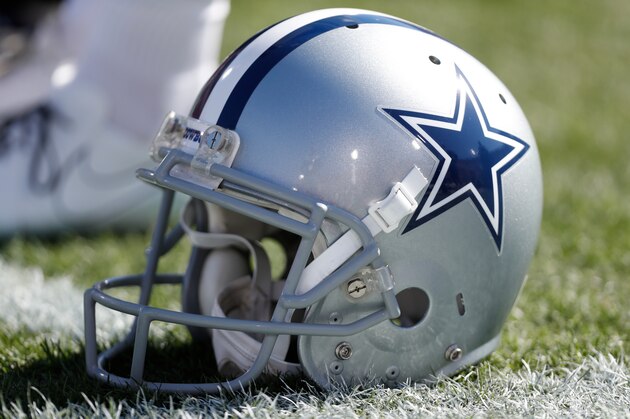 A Dallas Cowboys helmet rests on the turf during warmups before a preseason NFL football game against the Los Angeles Rams, Saturday, Aug. 13, 2016, in Los Angeles. (AP Photo/Ryan Kang)