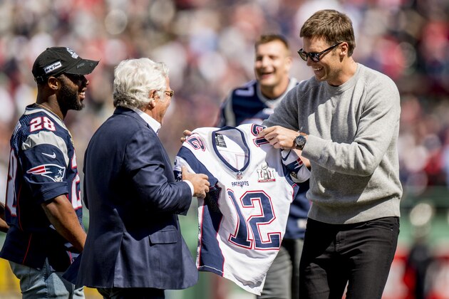 BOSTON, MA - APRIL 3: Tom Brady #12 of the New England Patriots hands his jersey to owner Robert Kraft during a pre-game ceremony before the Boston Red Sox home opener against the Pittsburgh Pirates on April 3, 2017 at Fenway Park in Boston, Massachusetts. (Photo by Billie Weiss/Boston Red Sox/Getty Images)