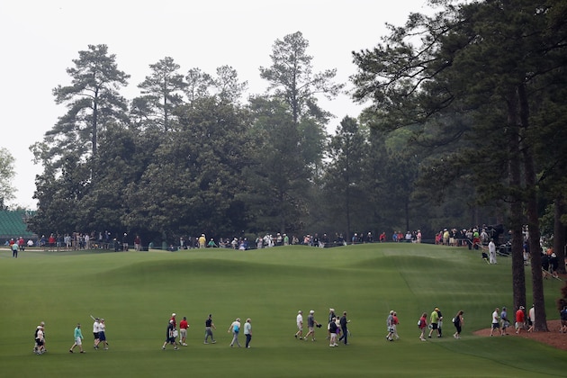 AUGUSTA, GA - APRIL 05:  Patrons walk across the second fairway after play was suspended due to inclement weather during a practice round prior to the start of the 2017 Masters Tournament at Augusta National Golf Club on April 5, 2017 in Augusta, Georgia.  (Photo by Rob Carr/Getty Images)
