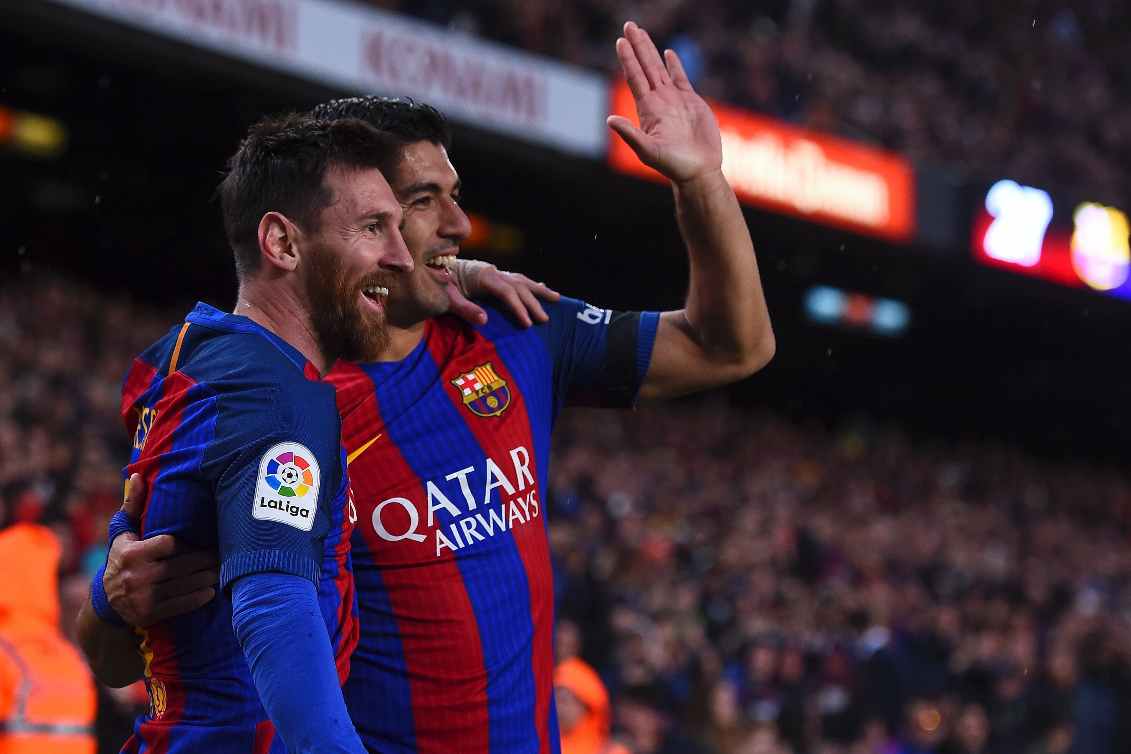 Barcelona's Argentinian forward Lionel Messi (L) is congratulated by Barcelona's Uruguayan forward Luis Suarez after scoring during the Spanish league football match FC Barcelona vs Sevilla FC at the Camp Nou stadium in Barcelona on April 5, 2017. / AFP PHOTO / Josep LAGO        (Photo credit should read JOSEP LAGO/AFP/Getty Images)