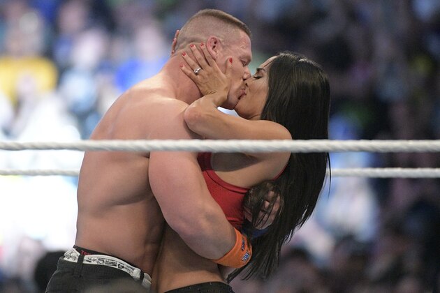 IMAGE DISTRIBUTED FOR WWE - WWE Superstars John Cena, left, and Nikki Bella kiss after she accepted his marriage proposal during WrestleMania 33 on Sunday, April 2, 2017, in Orlando, Fla. (Phelan M. Ebenhack/AP Images for WWE)