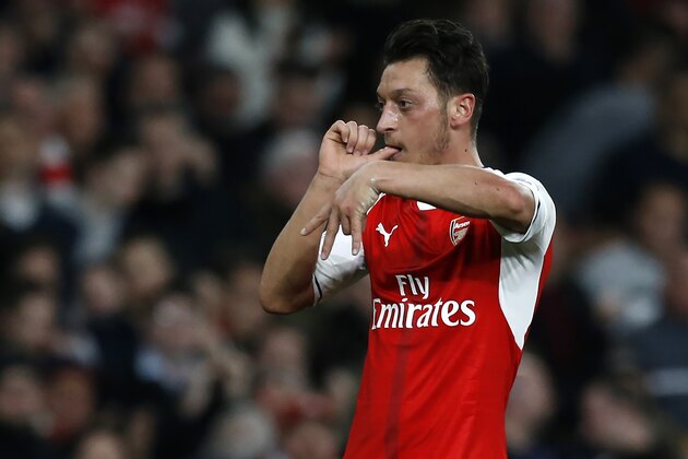 Arsenal's German midfielder Mesut Ozil celebrates after scoring the opening goal of the English Premier League football match between Arsenal and West Ham United at the Emirates Stadium in London on April 5, 2017.  / AFP PHOTO / Ian KINGTON / RESTRICTED TO EDITORIAL USE. No use with unauthorized audio, video, data, fixture lists, club/league logos or 'live' services. Online in-match use limited to 75 images, no video emulation. No use in betting, games or single club/league/player publications.  /         (Photo credit should read IAN KINGTON/AFP/Getty Images)