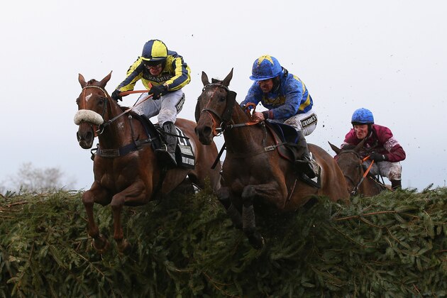 LIVERPOOL, ENGLAND - APRIL 09:  The Last Samuri ridden by David Bass and Vics Canvas ridden by Robert Dunne clear the last fence as eventual winner Rule The World ridden by David Mullins jumps it in third position during the Crabbie's Grand National Steeple Chase at Aintree Racecourse on April 9, 2016 in Liverpool, England.  (Photo by Alex Livesey/Getty Images)