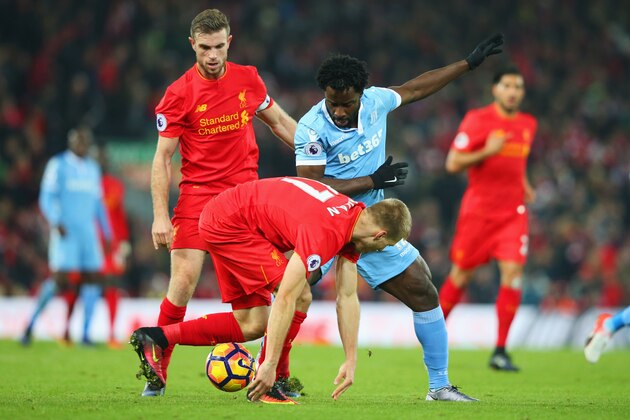 LIVERPOOL, ENGLAND - DECEMBER 27:  Wifried Bony of Stoke City battles with Jordan Henderson and Ragnar Klavan of Liverpool during the Premier League match between Liverpool and Stoke City at Anfield on December 27, 2016 in Liverpool, England.  (Photo by Alex Livesey/Getty Images)
