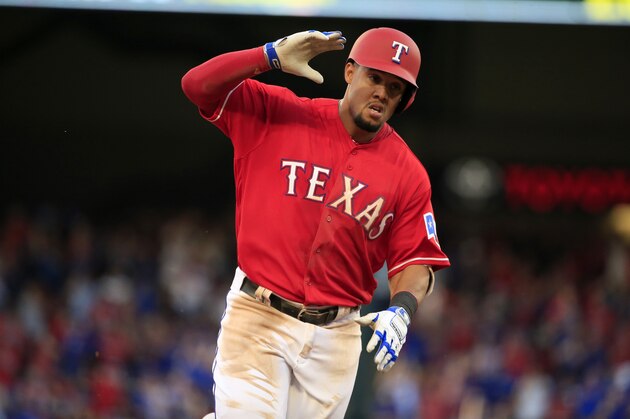 ARLINGTON, TX - APRIL 3: Carlos Gomez #14 of the Texas Rangers rounds third base after hitting a solo home run against the Cleveland Indians in the third inning on Opening Day at Globe Life Park in Arlington on April 3, 2017 in Arlington, Texas. (Photo by Ron Jenkins/Getty Images)