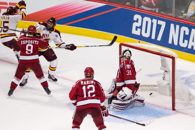 CHICAGO, IL - APRIL 6: Alex Iafallo #14 of the Minnesota Duluth Bulldogs deflects the puck past Merrick Madsen #31 of the Harvard Crimson for the winning goal with 26 seconds remaining during game one of the 2017 NCAA Division I Men's Hockey Frozen Four Championship Semifinal at the United Center on April 6, 2017 in Chicago, Illinois. The Bulldogs won 2-1. (Photo by Richard T Gagnon/Getty Images)