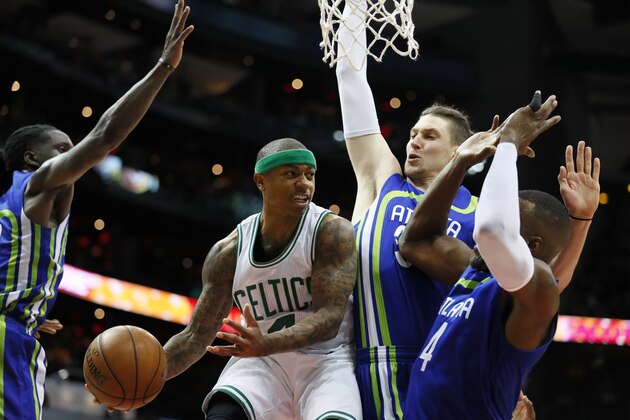 Boston Celtics guard Isaiah Thomas (4) passes as he is defended by Atlanta Hawks forward Thabo Sefolosha (25) in the first half of an NBA basketball game on Thursday, April 6, 2017, in Atlanta. (AP Photo/Todd Kirkland)