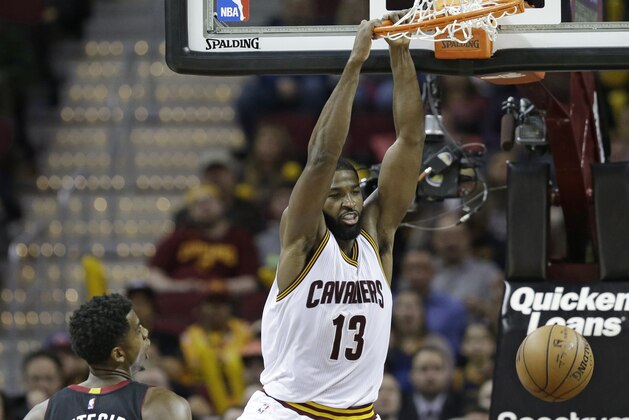 Cleveland Cavaliers' Tristan Thompson (13) dunks against Miami Heat's Hassan Whiteside (21) in the second half of an NBA basketball game, Monday, March 6, 2017, in Cleveland. The Heat won 106-98. (AP Photo/Tony Dejak)