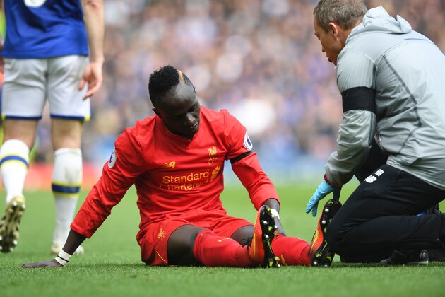 Liverpool's Senegalese midfielder Sadio Mane reacts as he receives medical attention after picking up an injury during the English Premier League football match between Liverpool and Everton at Anfield in Liverpool, north west England on April 1, 2017. / AFP PHOTO / Paul ELLIS / RESTRICTED TO EDITORIAL USE. No use with unauthorized audio, video, data, fixture lists, club/league logos or 'live' services. Online in-match use limited to 75 images, no video emulation. No use in betting, games or single club/league/player publications.  /         (Photo credit should read PAUL ELLIS/AFP/Getty Images)