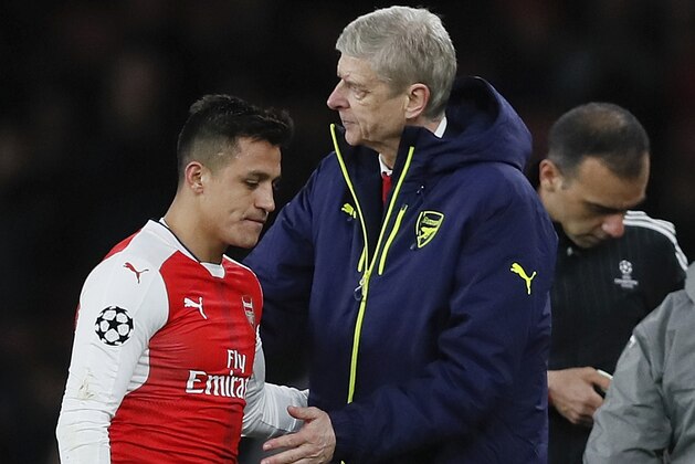 Arsenal's Alexis Sanchez, left, hugs with Arsenal manager Arsene Wenger during the Champions League round of 16 second leg soccer match between Arsenal and Bayern Munich at the Emirates Stadimum in London, Tuesday, March 7, 2017. (AP Photo/Kirsty Wigglesworth)