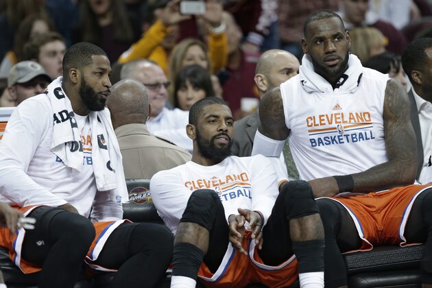 Cleveland Cavaliers' Tristan Thompson, left to right, Kyrie Irving and LeBron James watch from the bench in the second half of an NBA basketball game against the Philadelphia 76ers, Friday, March 31, 2017, in Cleveland. (AP Photo/Tony Dejak)