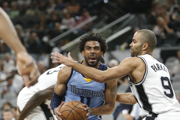 SAN ANTONIO,TX - APRIL  4:  Mike Conley #11 of the Memphis Grizzlies drives by Tony Parker #9 of the San Antonio Spurs at AT&T Center on April 4, 2017 in San Antonio, Texas.  NOTE TO USER: User expressly acknowledges and agrees that , by downloading and or using this photograph, User is consenting to the terms and conditions of the Getty Images License Agreement. (Photo by Ronald Cortes/Getty Images)