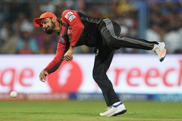 Royal Challengers Bangalore captain Virat Kohli fields the ball during the 2016 Indian Premier League (IPL) Twenty20 cricket match between Kolkata Knight Riders and Royal Challengers Bangalore at the Eden Gardens Cricket Stadium in Kolkata on May 16, 2016.  ----IMAGE RESTRICTED TO EDITORIAL USE - STRICTLY NO COMMERCIAL USE----- / GETTYOUT' / AFP / Dibyangshu SARKAR        (Photo credit should read DIBYANGSHU SARKAR/AFP/Getty Images)