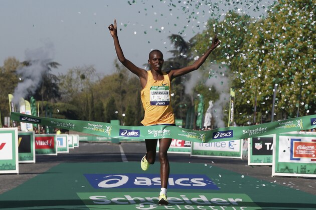 Paul Lonyangata of Kenya crosses the finish line to win the 41st Paris Marathon men's race in Paris, Sunday, April 9, 2017. (AP Photo/Thibault Camus)