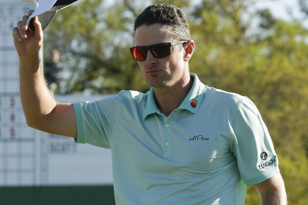 Justin Rose, of England, tips his hat on the 18th hole during the third round of the Masters golf tournament Saturday, April 8, 2017, in Augusta, Ga. (AP Photo/Charlie Riedel)