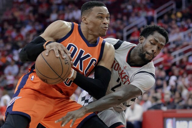 Oklahoma City Thunder's Russell Westbrook (0) protects the ball from the steal attempt by Houston Rockets' Patrick Beverley (2) in the first half of an NBA basketball game in Houston, Sunday, March 26, 2017. (AP Photo/Michael Wyke)