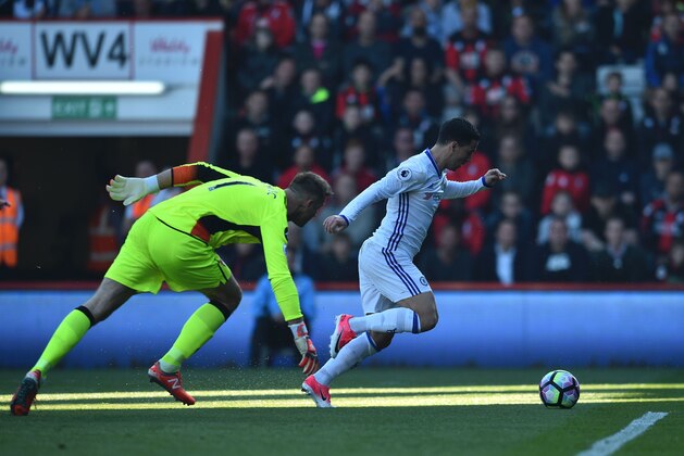 Chelsea's Belgian midfielder Eden Hazard (R) rounds Bournemouth's Polish goalkeeper Artur Boruc (L) to score their second goal during the English Premier League football match between Bournemouth and Chelsea at the Vitality Stadium in Bournemouth, southern England on April 8, 2017. / AFP PHOTO / Glyn KIRK / RESTRICTED TO EDITORIAL USE. No use with unauthorized audio, video, data, fixture lists, club/league logos or 'live' services. Online in-match use limited to 75 images, no video emulation. No use in betting, games or single club/league/player publications.  /         (Photo credit should read GLYN KIRK/AFP/Getty Images)
