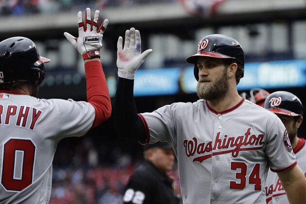 Washington Nationals' Bryce Harper (34) celebrates with teammate Daniel Murphy after hitting a two run home run in the first inning of a baseball game against the Philadelphia Phillies in Philadelphia, Friday, April 7, 2017. (AP Photo/Matt Rourke)