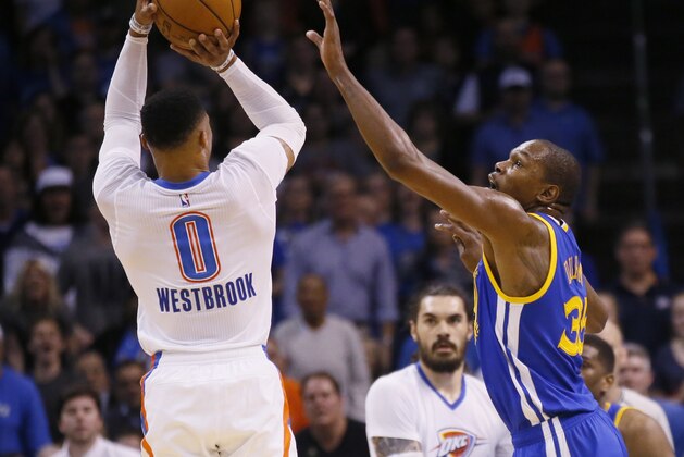 Oklahoma City Thunder guard Russell Westbrook (0) shoots over Golden State Warriors forward Kevin Durant, right, in the first quarter of an NBA basketball game in Oklahoma City, Saturday, Feb. 11, 2017. (AP Photo/Sue Ogrocki)