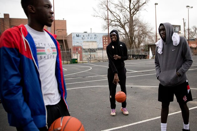 From left, Wanjang Tut, Ed Chang and Aguek Arop shoot baskets on March 30, 2017, at the George Bryant Basketball Center in Omaha, Nebraska.