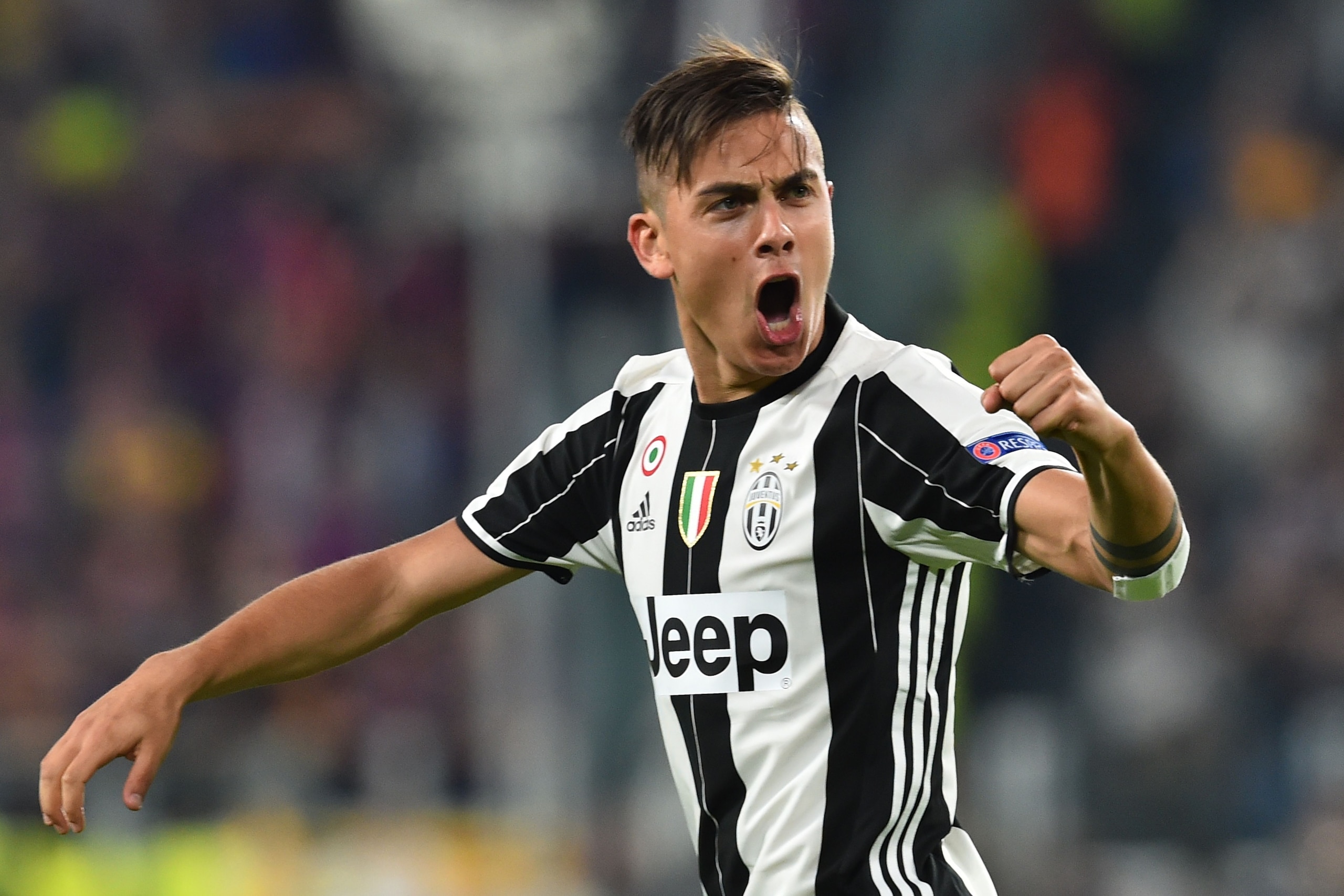 Juventus' forward from Argentina Paulo Dybala celebrates after scoring during the UEFA Champions League quarter final first leg football match Juventus vs Barcelona, on April 11, 2017 at the Juventus stadium in Turin.  / AFP PHOTO / GIUSEPPE CACACE        (Photo credit should read GIUSEPPE CACACE/AFP/Getty Images)