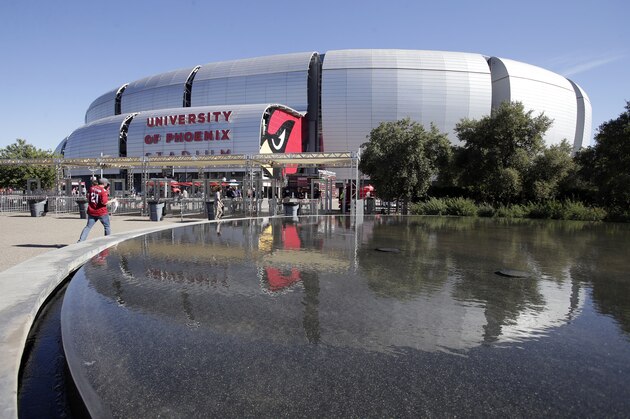 Fans arrive at University of Phoenix Stadium prior to an NFL football game between the New York Jets and the Arizona Cardinals, Monday, Oct. 17, 2016, in Glendale, Ariz. (AP Photo/Rick Scuteri)