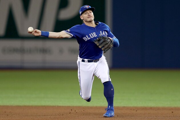 TORONTO, ON - OCTOBER 18:  Josh Donaldson #20 of the Toronto Blue Jays fields the ball hit by Lonnie Chisenhall #8 of the Cleveland Indians in the fifth inning during game four of the American League Championship Series at Rogers Centre on October 18, 2016 in Toronto, Canada.  (Photo by Elsa/Getty Images)