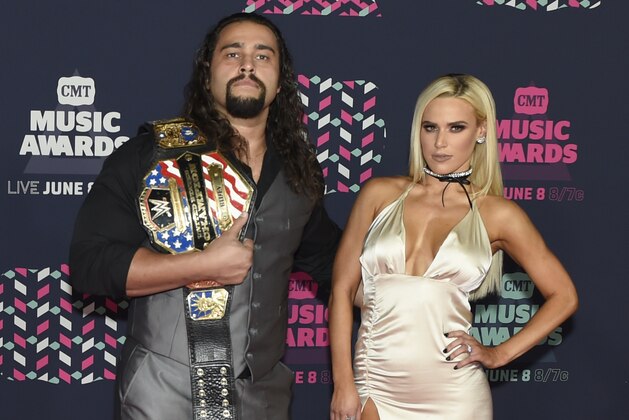 Professional wrestler Alexander Rusev, left, and Lana arrive at the CMT Music Awards at the Bridgestone Arena on Wednesday, June 8, 2016, in Nashville, Tenn. (Photo by Sanford Myers/Invision/AP)