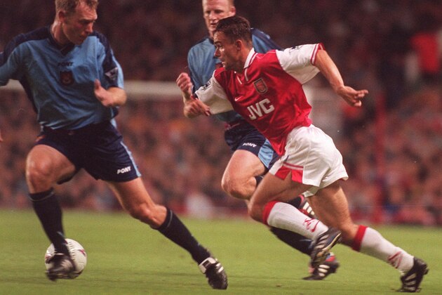 Arsenals Marc Overmars, right, darts between Tim Breacker and Ian Dowie, left, of West Ham to score one of his two goals in Arsenals 4-0 victory at their Highbury stadium in London, Wednesday September 24 1997.  This result took Arsenal to the top of the English Premier League.  (AP Photo / David Thompson)