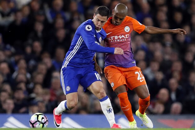 Chelsea's Eden Hazard, left, and Manchester City's Fernandinho Luiz Roza, right, challenge for the ball during the English Premier League soccer match between Chelsea and Manchester City at the Stamford Bridge stadium in London, Great Britain, Wednesday, April 5, 2017. (AP Photo/Kirsty Wigglesworth)