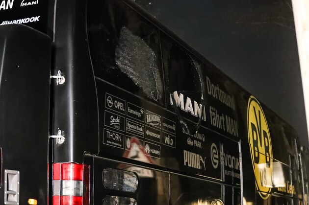 DORTMUND, GERMANY - APRIL 12: Team bus of the Borussia Dortmund football club damaged in an explosion is seen on April 12, 2017 in Dortmund, Germany. According to police an explosion detonated as the bus was leaving the hotel where the team was staying to bring them to their Champions League game against Monaco. So far one person, team member Marc Bartra, is reported injured.   (Photo by Maja Hitij/Getty Images)