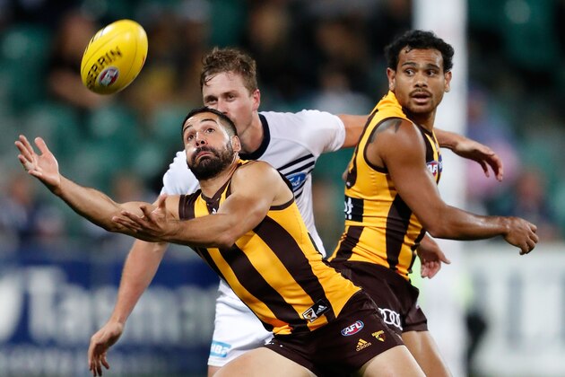 LAUNCESTON, AUSTRALIA - FEBRUARY 17: Paul Puopolo of the Hawks reaches for the ball ahead of Mitch Duncan of the Cats and Cyril Rioli of the Hawks during the AFL 2017 JLT Community Series match between the Hawthorn Hawks and the Geelong Cats at the University of Tasmania Stadium on February 17, 2017 in Launceston, Australia. (Photo by Adam Trafford/AFL Media/Getty Images)