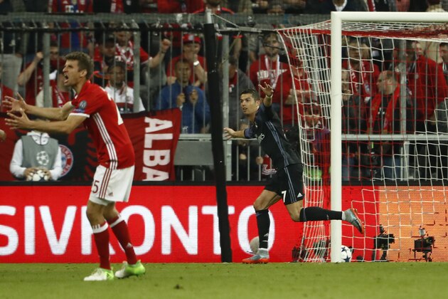 Real Madrid's Portuguese forward Cristiano Ronaldo (R) celebrates scoring the 1-2 goal during the UEFA Champions League 1st leg quarter-final football match FC Bayern Munich v Real Madrid in Munich, southen Germany on April 12, 2017. / AFP PHOTO / Odd ANDERSEN        (Photo credit should read ODD ANDERSEN/AFP/Getty Images)