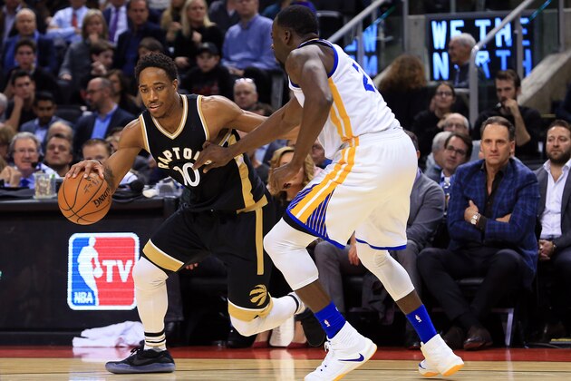 TORONTO, ON - NOVEMBER 16:  DeMar DeRozan #10 of the Toronto Raptors dribbles the ball as Draymond Green #23 of the Golden State Warriors defends during the second half of an NBA game at Air Canada Centre on November 16, 2016 in Toronto, Canada.  NOTE TO USER: User expressly acknowledges and agrees that, by downloading and or using this photograph, User is consenting to the terms and conditions of the Getty Images License Agreement.  (Photo by Vaughn Ridley/Getty Images)