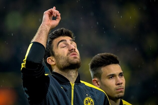 Dortmund's Greek defender Sokratis (L) and Dortmund's Portuguese defender Raphael Guerreiro are pictured prior to the UEFA Champions League 1st leg quarter-final football match BVB Borussia Dortmund v Monaco in Dortmund, western Germany on April 12, 2017. / AFP PHOTO / SASCHA SCHUERMANN        (Photo credit should read SASCHA SCHUERMANN/AFP/Getty Images)