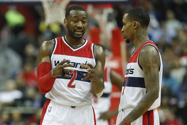 Washington Wizards guard John Wall (2) talks with teammate Brandon Jennings (7) during the second half of an NBA basketball game against the Miami Heat in Washington, Saturday, April 8, 2017. Miami won 106-103. (AP Photo/Pablo Martinez Monsivais)
