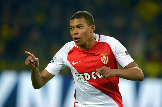TOPSHOT - Monaco's French forward Kylian Mbappe Lottin reacts after scoring during the UEFA Champions League 1st leg quarter-final football match BVB Borussia Dortmund v Monaco in Dortmund, western Germany on April 12, 2017.
The match had been postponed after three explosions hit German football team Borussia Dortmund's bus late on April 11, 2017 ahead of a Champions League home game. / AFP PHOTO / Sascha Schuermann        (Photo credit should read SASCHA SCHUERMANN/AFP/Getty Images)