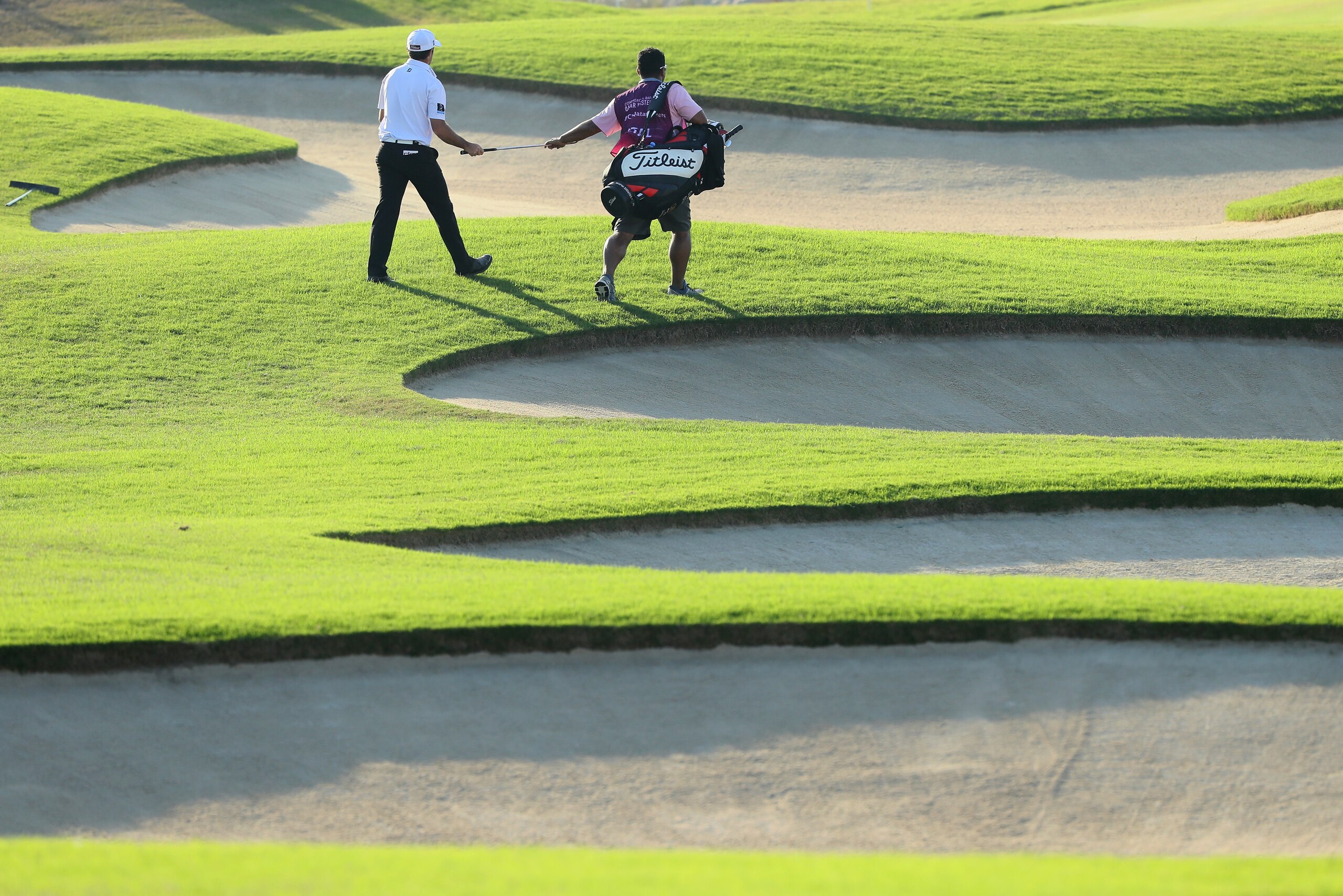 DOHA, QATAR - JANUARY 27:  Gary Stal of France and his caddie walk upp the seventh hole during the second round of the Commercial Bank Qatar Masters at the Doha Golf Club on January 27, 2017 in Doha, Qatar.  (Photo by Andrew Redington/Getty Images)